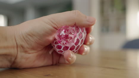 person holding a pink glitter stress ball