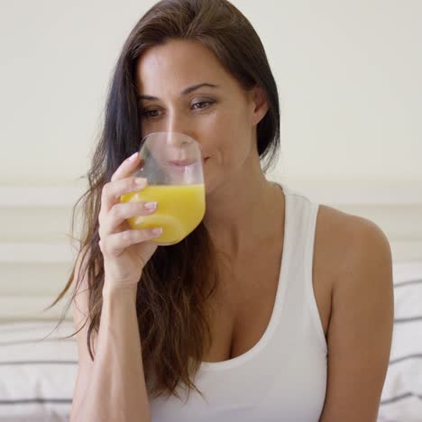 young woman enjoying a glass of orange juice