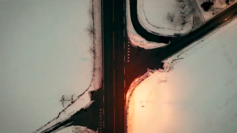 Aerial-over-a-road-junction-in-an-snowy-landscape-near-Voss,-Norway