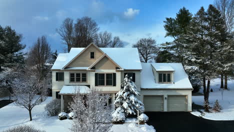 two story family home and garage, driveway in usa covered in fresh winter snow