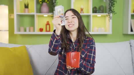 happy asian young woman with money.