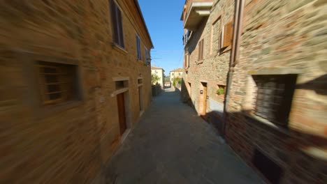 drone flying through alleyway in community of sinalunga, tuscany italy - aerial