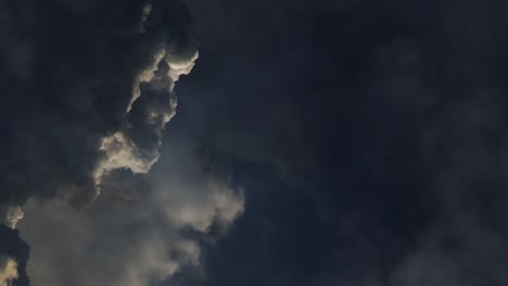 dark cumulonimbus clouds with lightning bolting, point of view