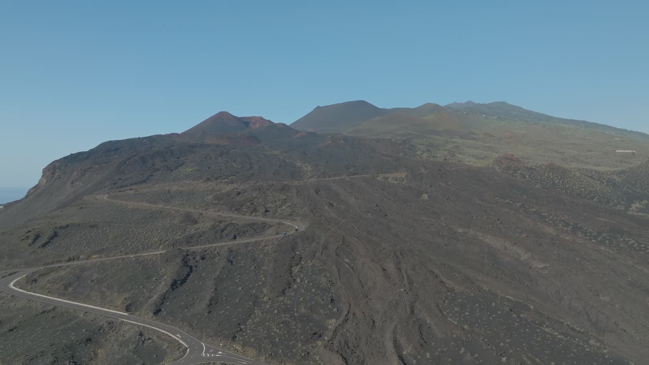Road leading up to volcanic mountain range on La Palma island, aerial