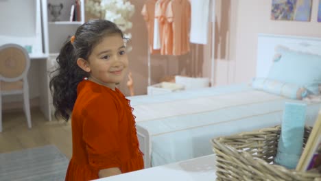 happy little girl looking at herself in the mirror.