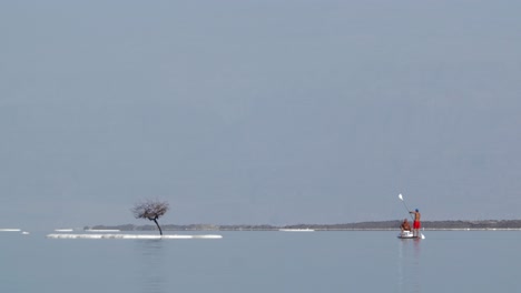 Water-tour-on-paddle-board-to-look-at-salty-islets-of-Dead-Sea