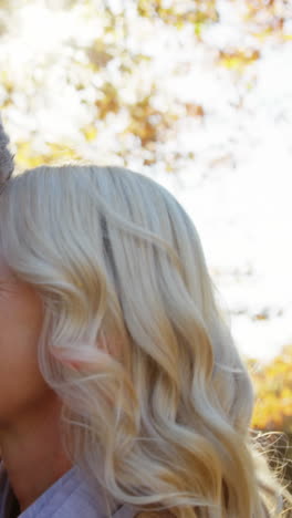 man and woman touching noses outdoors