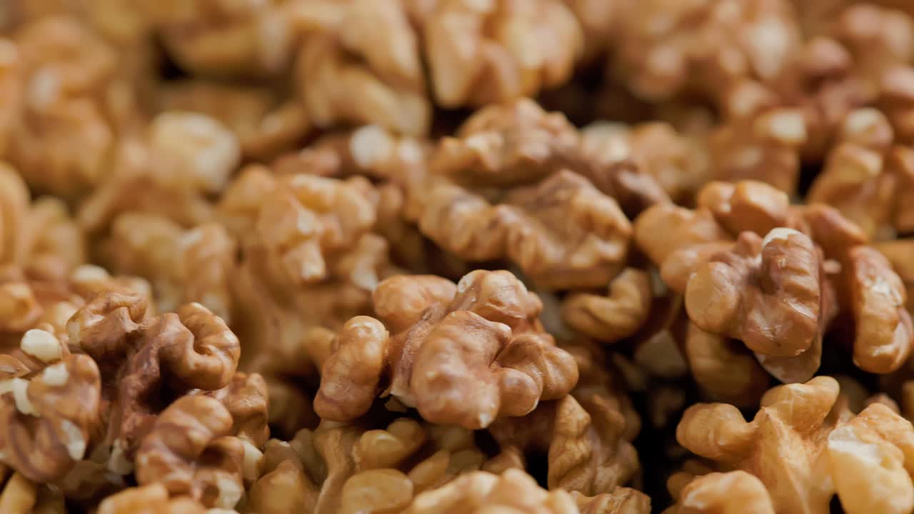looped spinning walnuts without the shell close-up full frame background