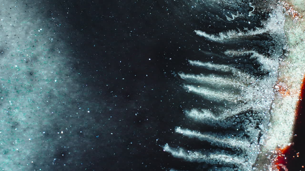 Macro of pigment dissolving in liquid with artistic texture effect