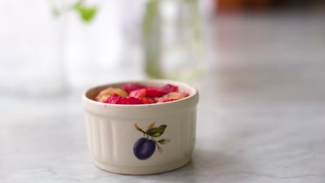 strawberry-and-banana-fruit-salad-in-a-bowl-on-a-marble-counter