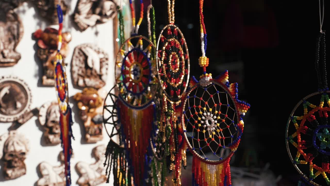 Feathers amulet Dream catcher with white feathers flying in wind sun.