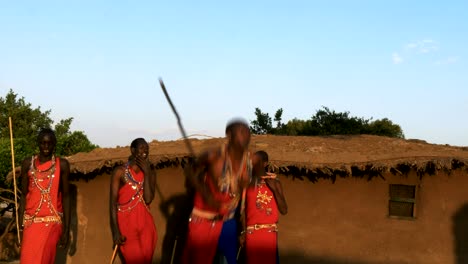 close up of five maasai warriors dancing