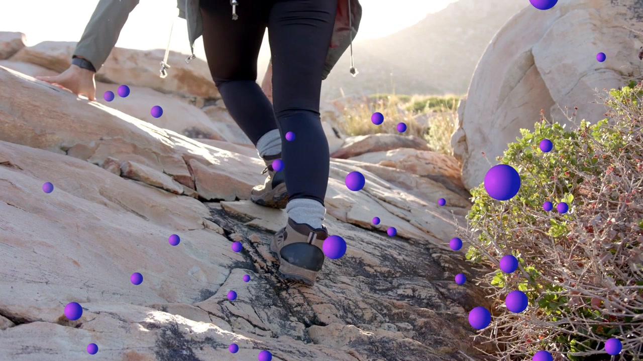 Female hiker stepping rock ledge shifting and sparking purple tech particles guiding ascent to sun