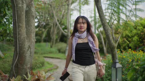 indonesian woman strolling through an urban green space