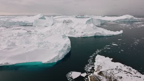 drone over sea and ice of ilulissat icefjord