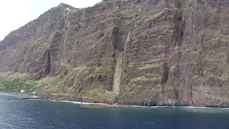 Waterfall-Cascading-Over-A-Sheer-Cliff---aerial-drone-shot