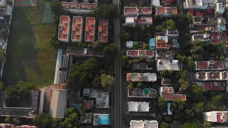 Top-down-look-at-pedestrian-road-going-between-houses-leading-to-a-v-shaped-bridge-over-traintracks