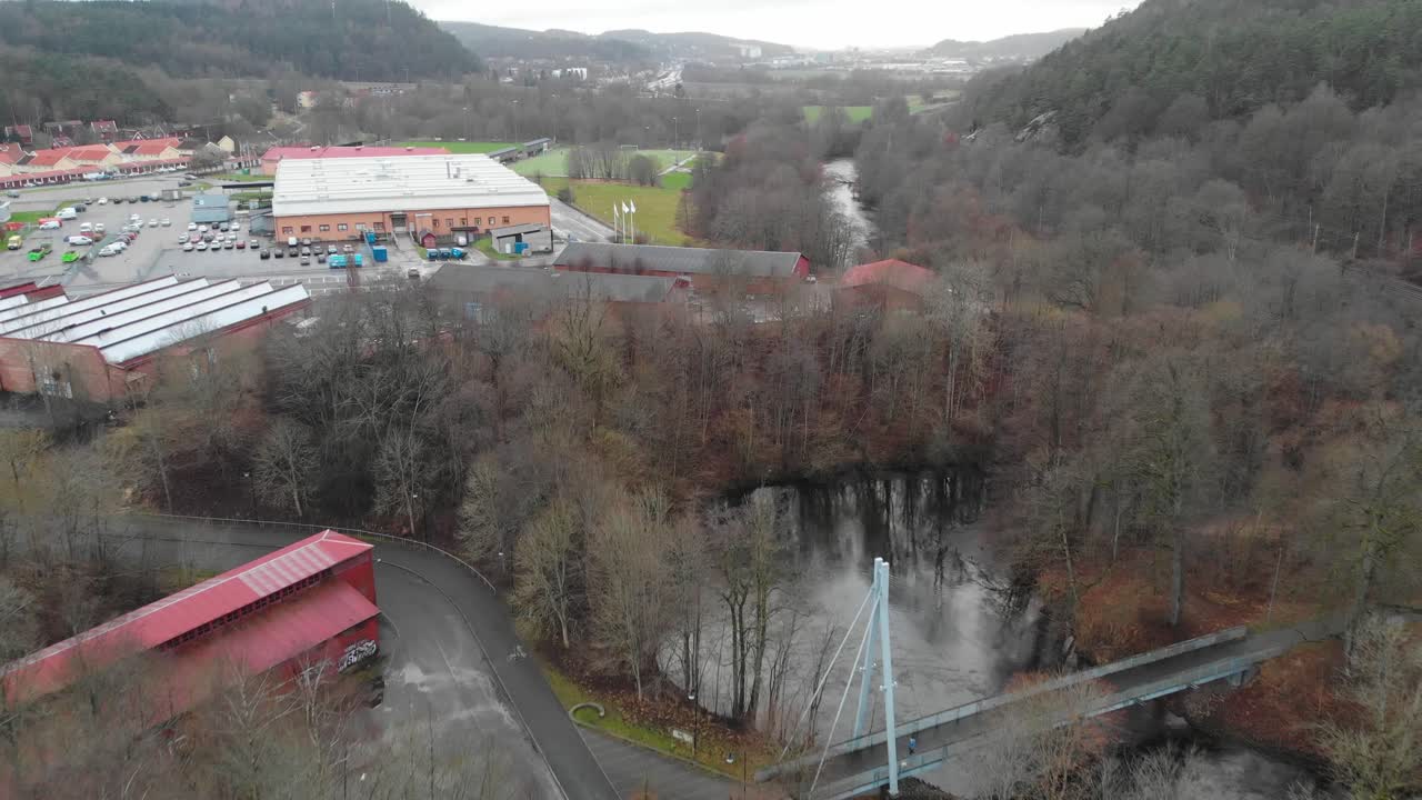 toma aérea de edificios industriales y parque con río en una ciudad durante el invierno, suecia