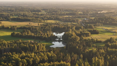 beautiful green latvian countryside with lakes, forests, rivers, and grasslands.