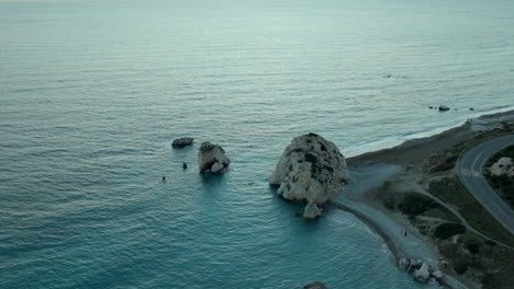 Petra-tou-Romiou-or-Aphrodite's-Rock---sea-stack-and-famous-tourist-travel-destination-landmarkin-Paphos,-Cyprus---Aerial-View-at-Sunset