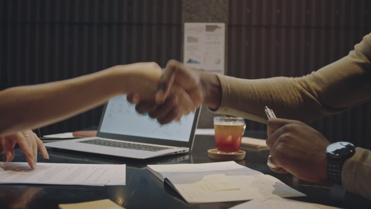 Handshake of Multiethnic Business Partners in Cafe