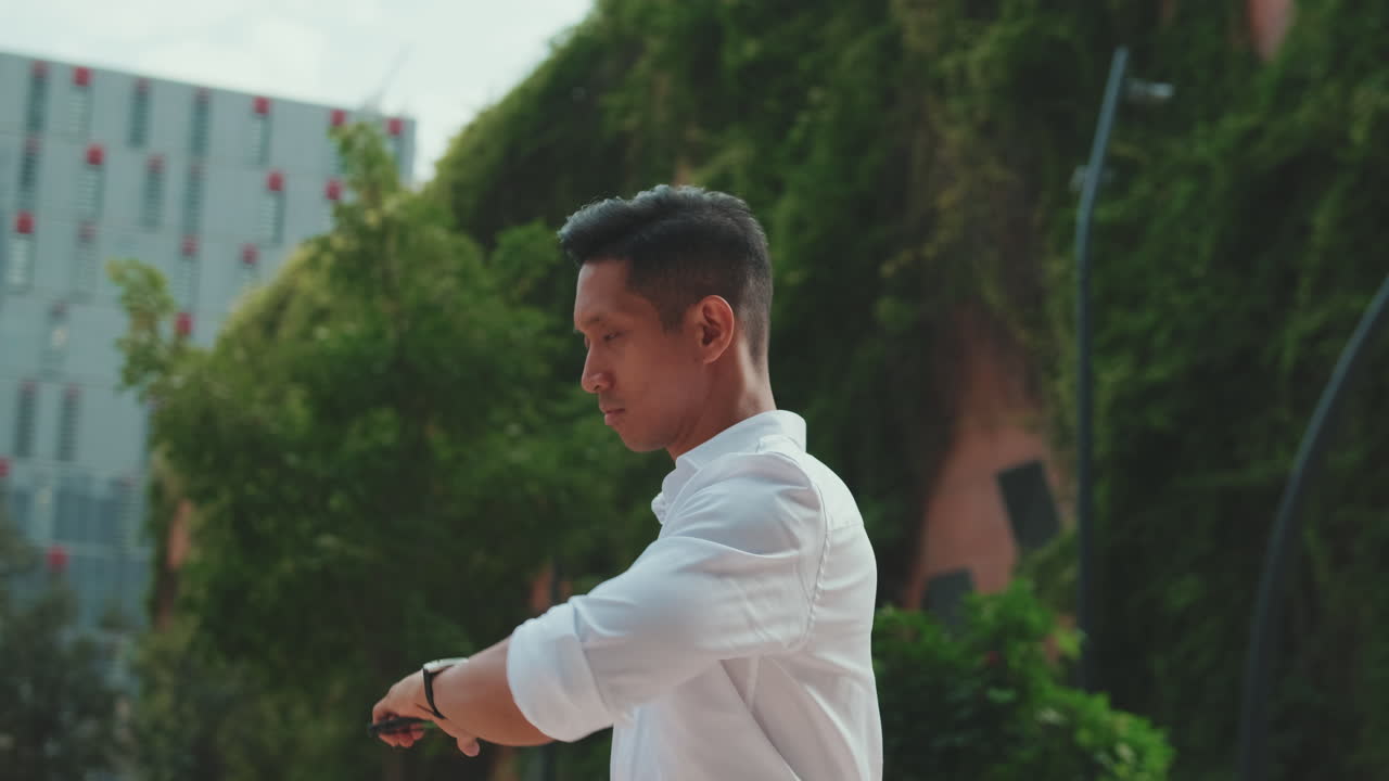 Man in white shirt walking in the city