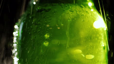 splashes of cold water fall on a glass bottle with a soft drink or beer quench your thirst concept 4