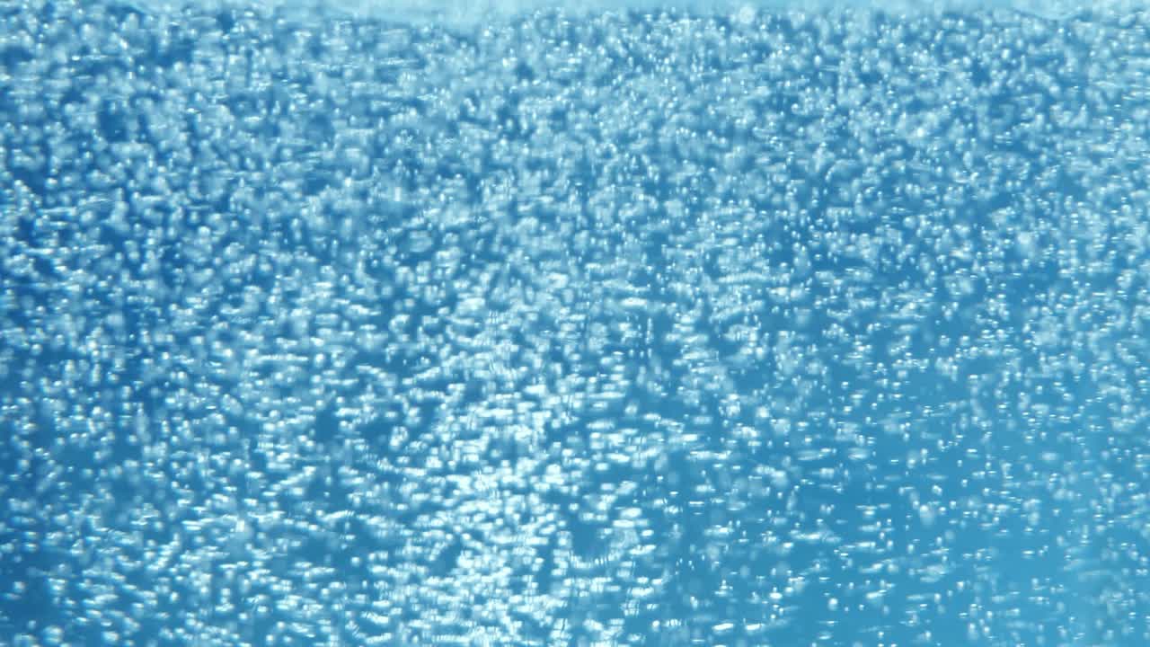 The carbonated water is filled with sugar, blue background