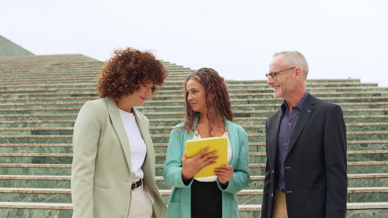 Business professionals having a conversation on steps