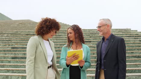 business professionals having a conversation on steps