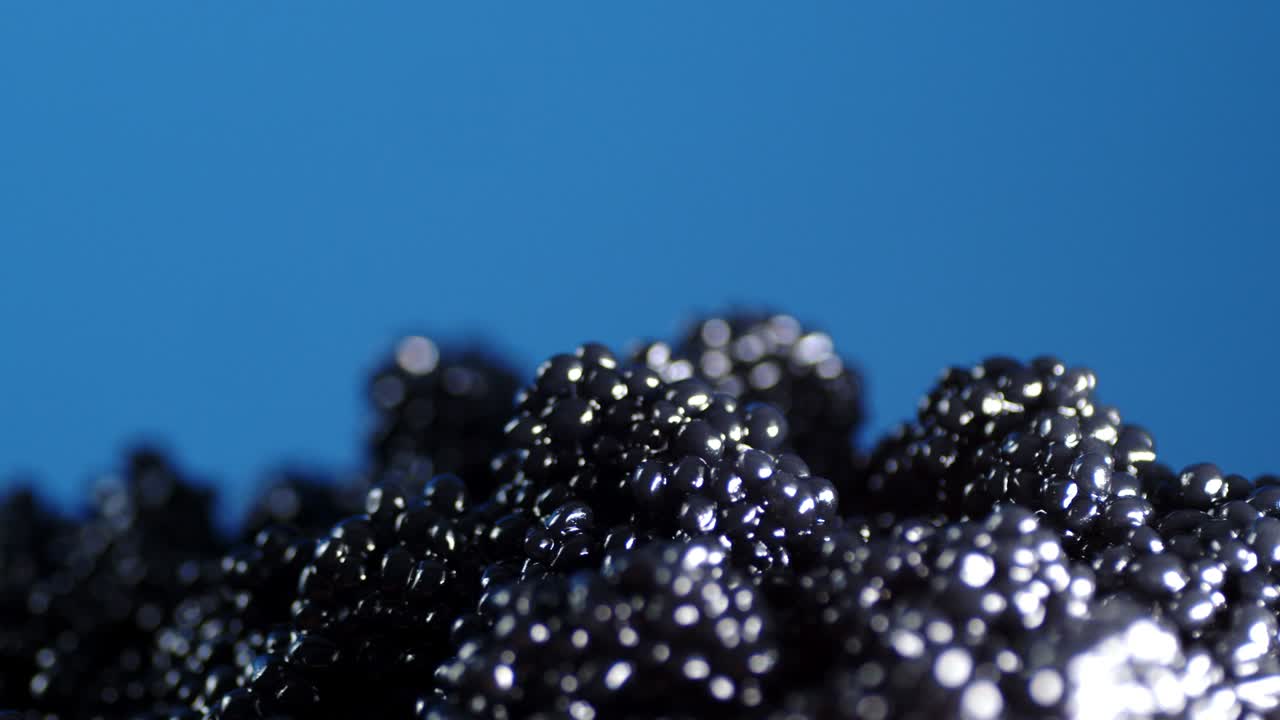 A pile of fresh black caviar rotating slowly.