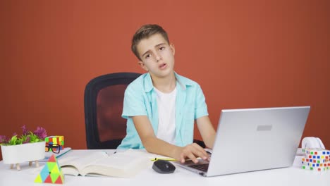 Negative-expression-of-boy-using-laptop.