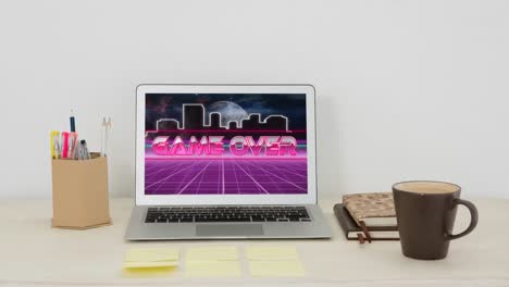 Animation-of-game-over-text-on-laptop-screen-on-desk