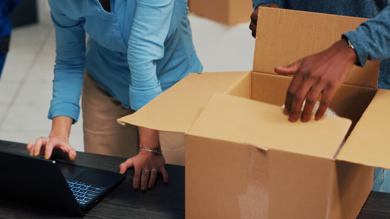 Couple packing boxes for moving