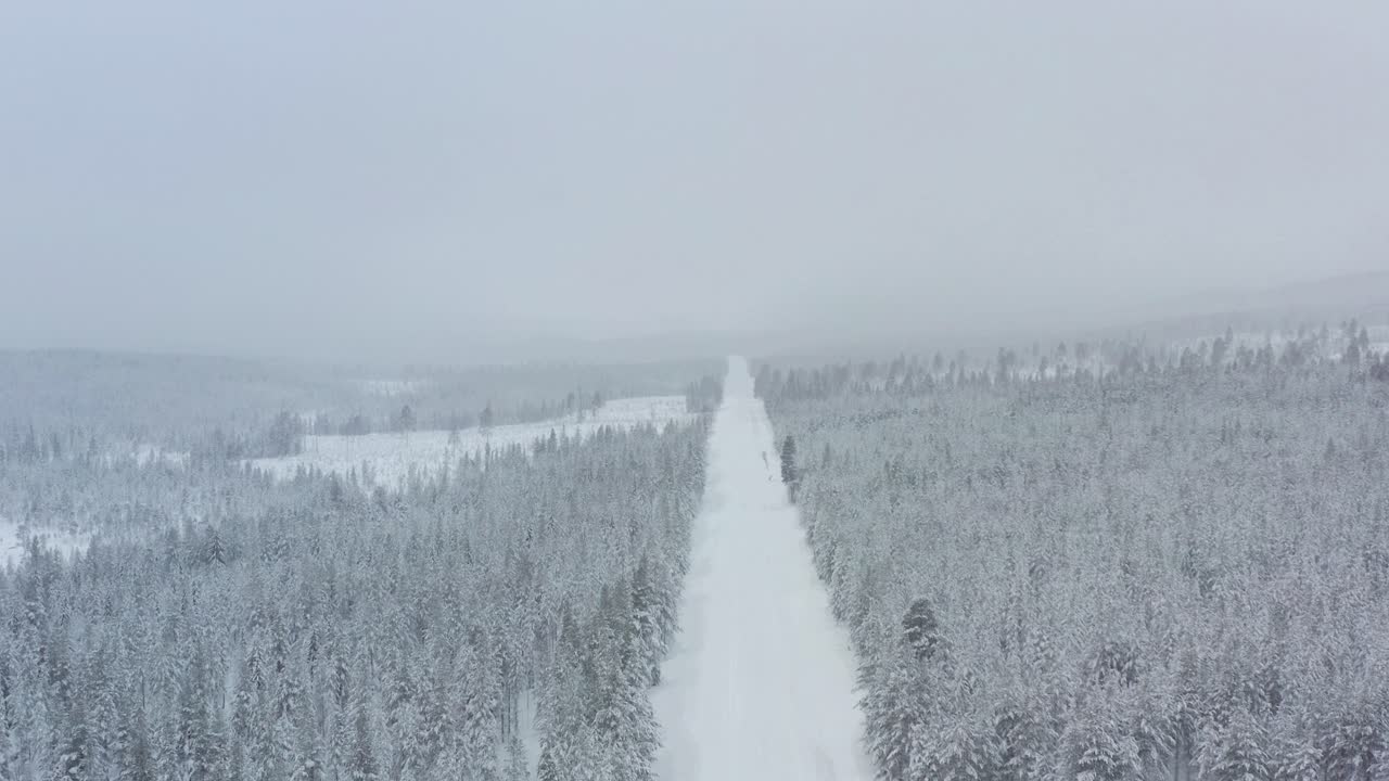 High angle shot of an empty road in the middle of Lapland during winter.