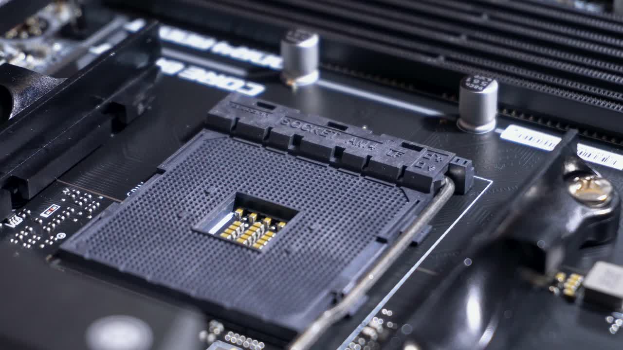 Central processing unit (CPU) pin grid array socket inside computer, slow pan right, close up