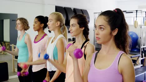 Beautiful-women-exercising-in-fitness-studio