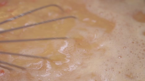 close-up of whisking liquid ingredients