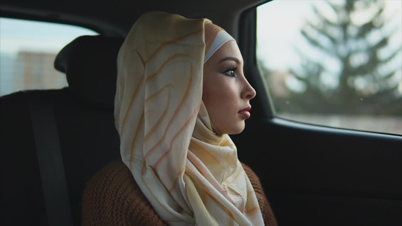 Woman in Hijab Traveling by Car