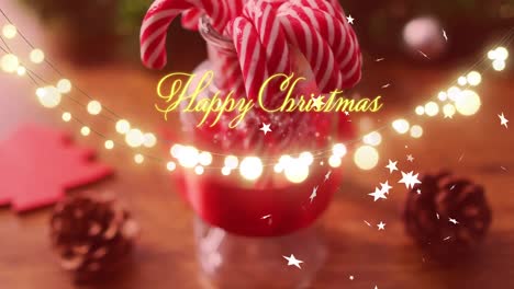 Animation-of-happy-christmas-text-over-candy-canes