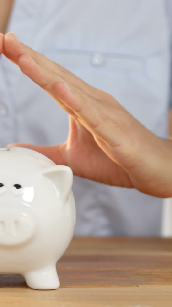 Woman gesturing on piggy bank