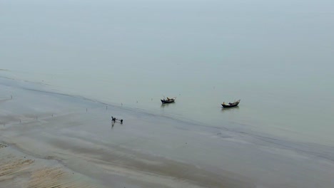 asian fishing trawler boats leaving shore, bangladesh