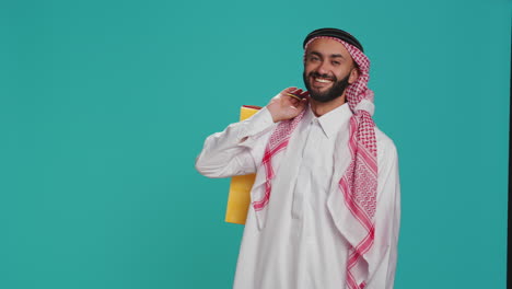 joyful guy carries colorful shopping bags