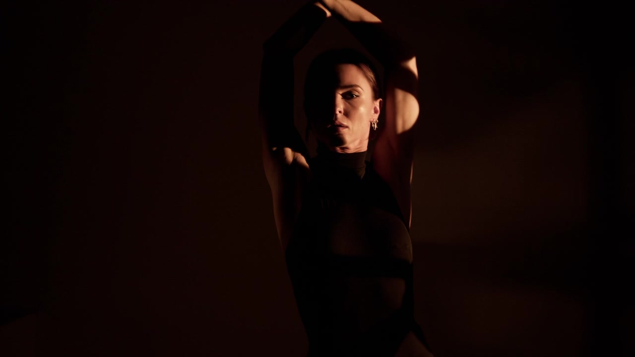 Confident young woman performing a modern high heels dance routine with passion and grace