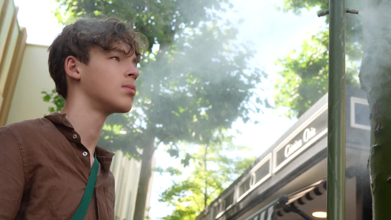 Teen Cooling Off with Mist in Spain