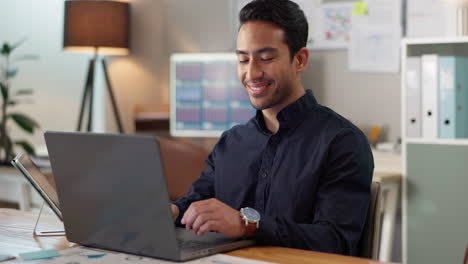 Happy-man-in-office,-typing-on-laptop