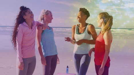 on sunny beach, women in activewear having animated conversation together