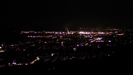 Vista-Nocturna-De-La-Carretera-Distante-Iluminada-Del-Centro-Con-Tráfico