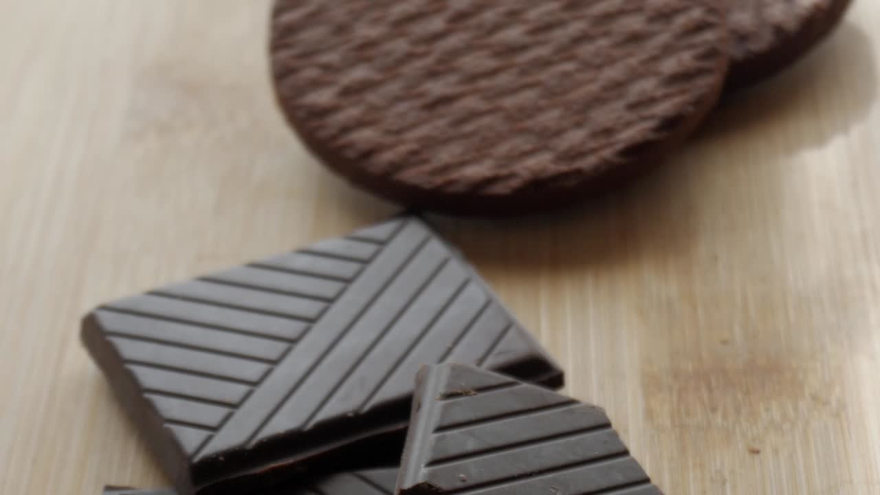 Rich, textured dark chocolate biscuits, stacked on a wooden surface, ready to be enjoyed