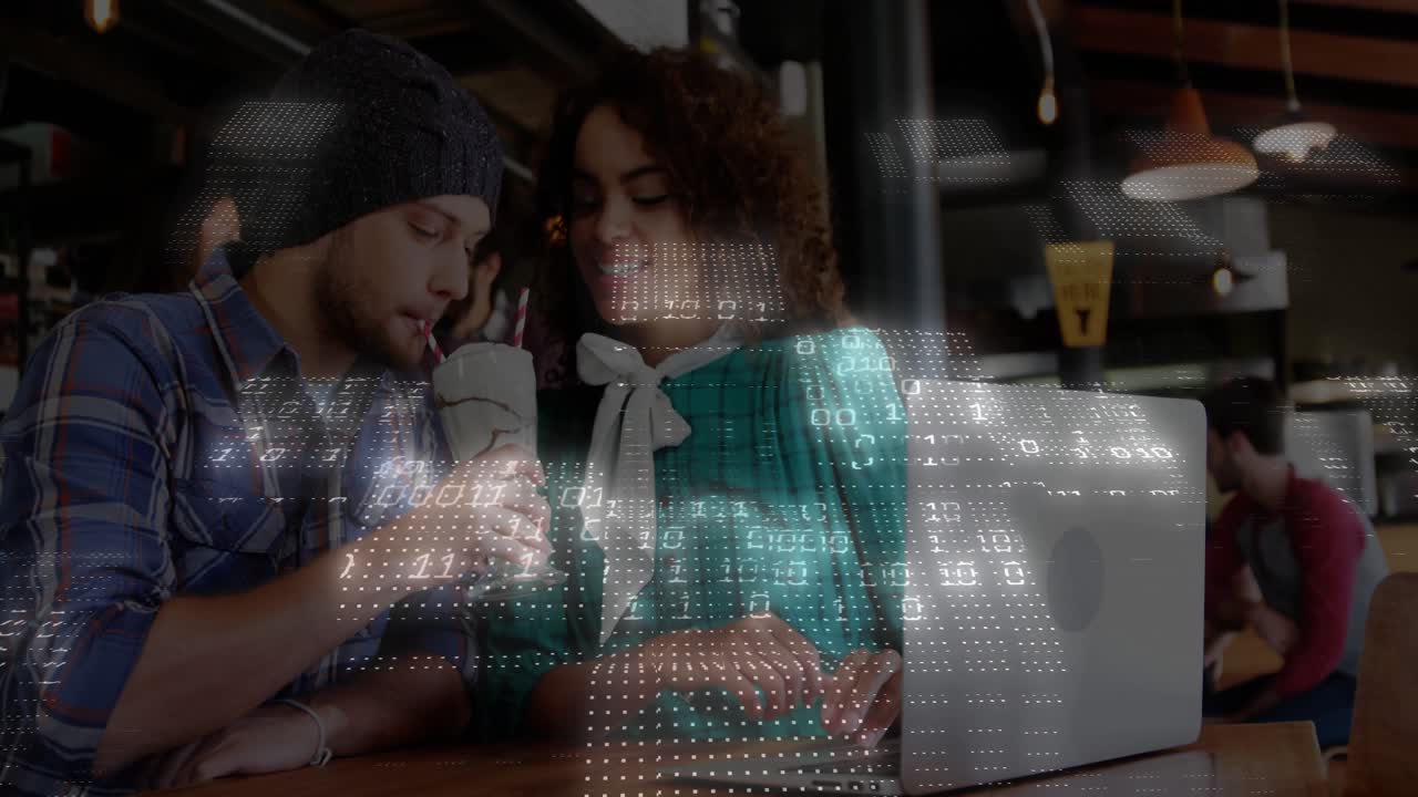 Friends tapping laptop trackpad and sharing drink for tech demo as digital code overlay intensifies